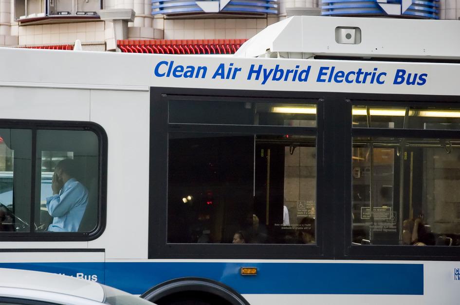 Clean Air Electric Bus driving in city.