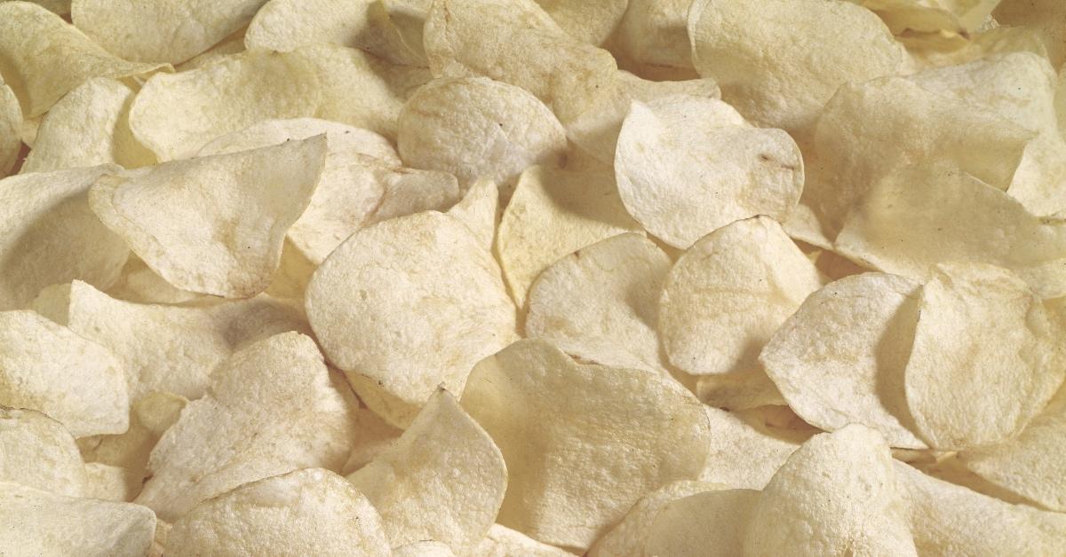 Close-up photograph of potato chips on a table. 