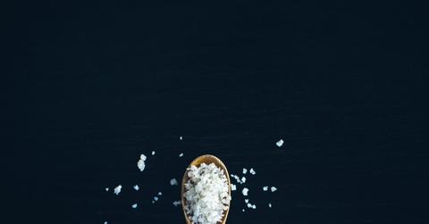 A tablespoon of Celtic salt on an outstretched wooden spoon