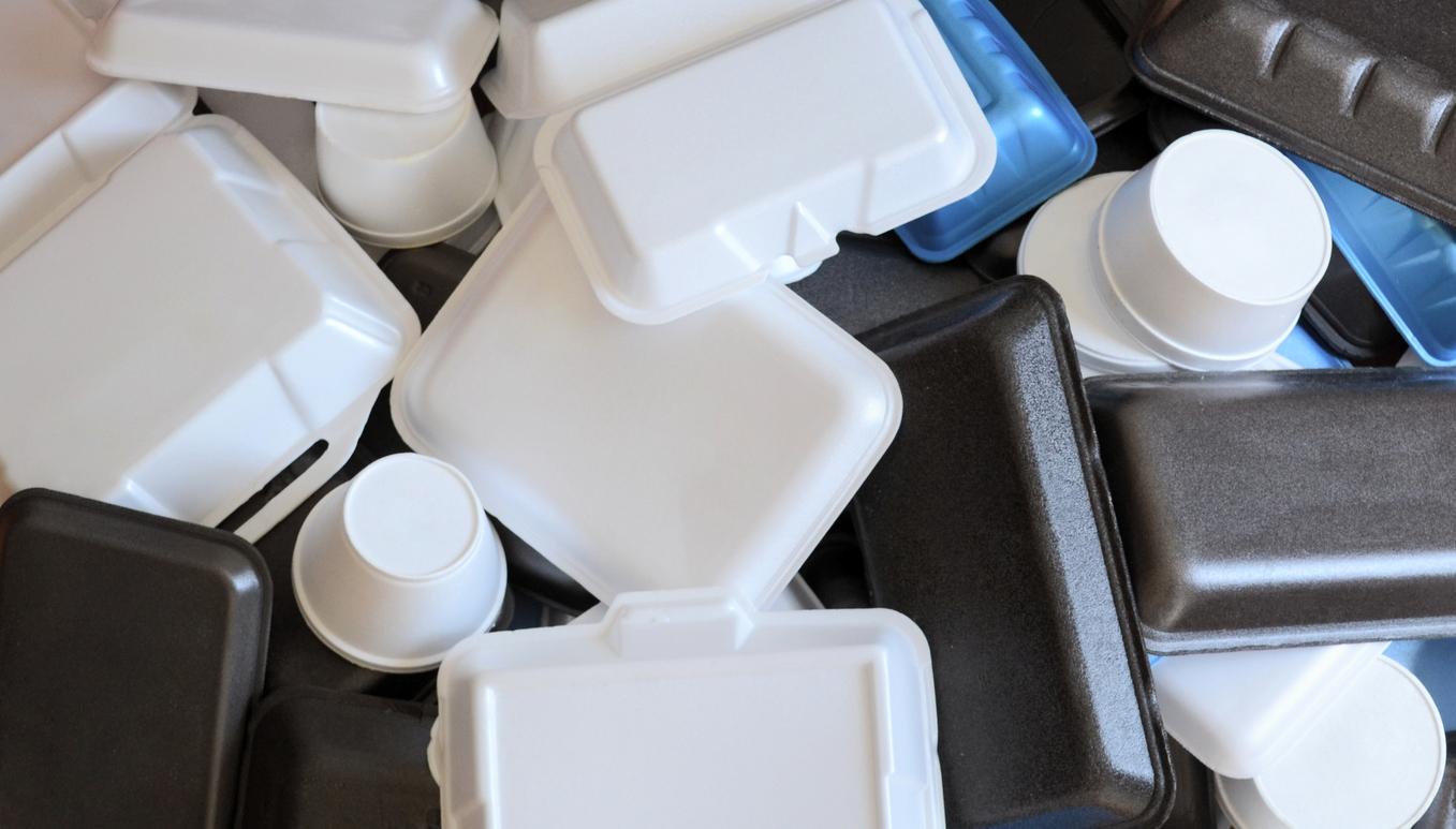 A collection of black and white Styrofoam containers of various sizes.