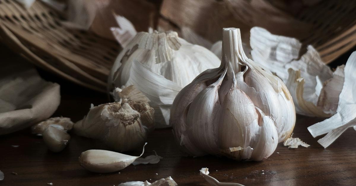 Cloves of garlic peeled on a wooden table. 