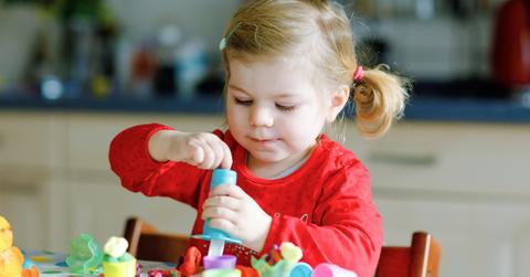 Toddler plays with crafting set