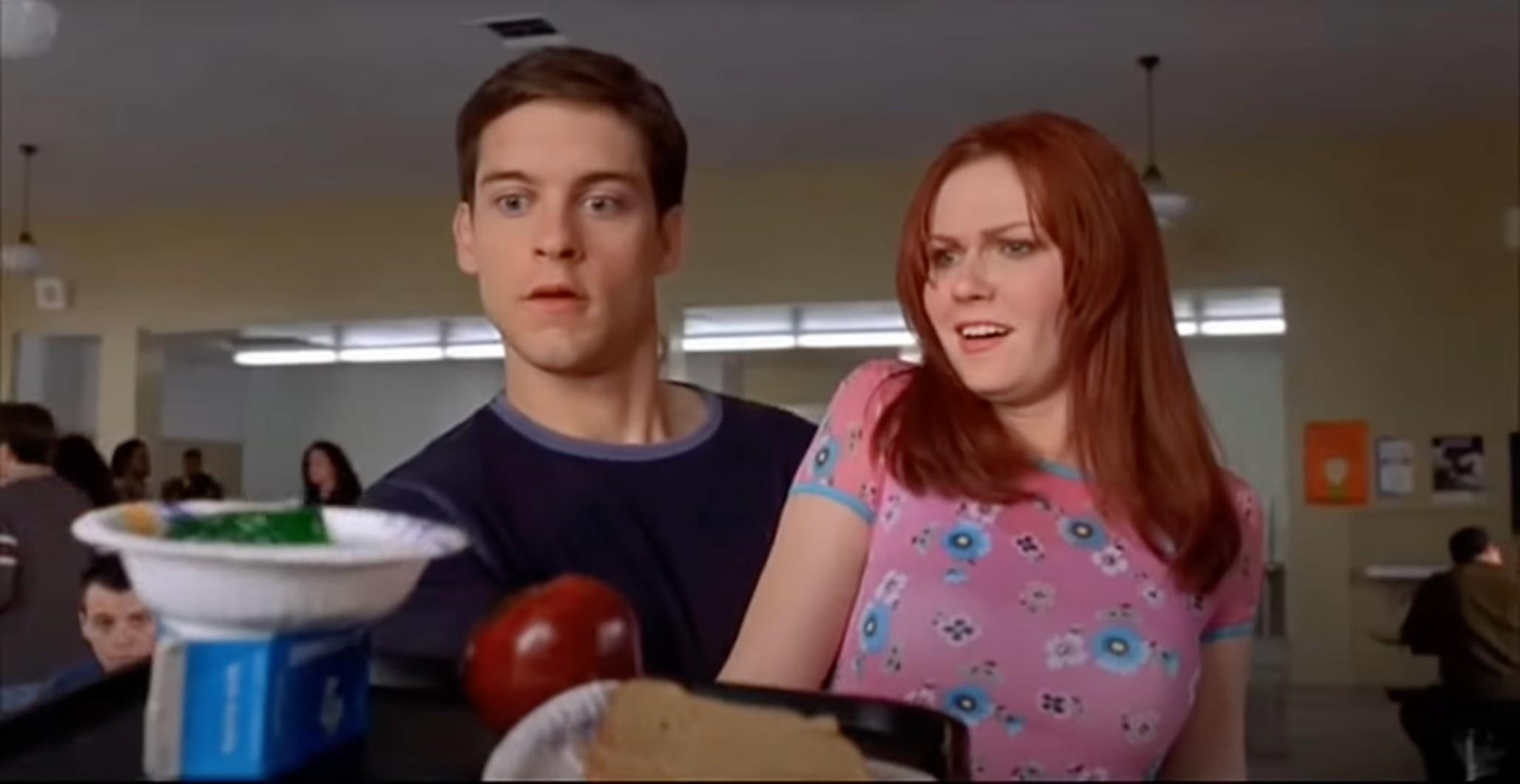 Tobey Maguire joins Kirsten Dunst in the cafeteria in a scene from Spider-Man in 2002.