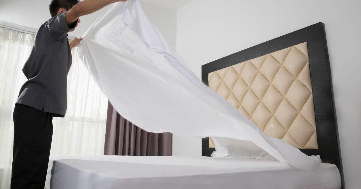 A man making his bed by spreading out the bed sheet. (Representative Cover Image Source: Getty Images | Gary John Norman)