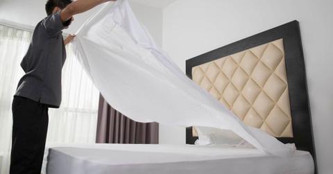 A man making his bed by spreading out the bed sheet. (Representative Cover Image Source: Getty Images | Gary John Norman)