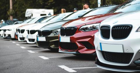 A row of cars sits on a lot