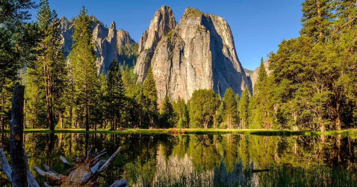 Yosemite National Park lake and mountainside with forest. 