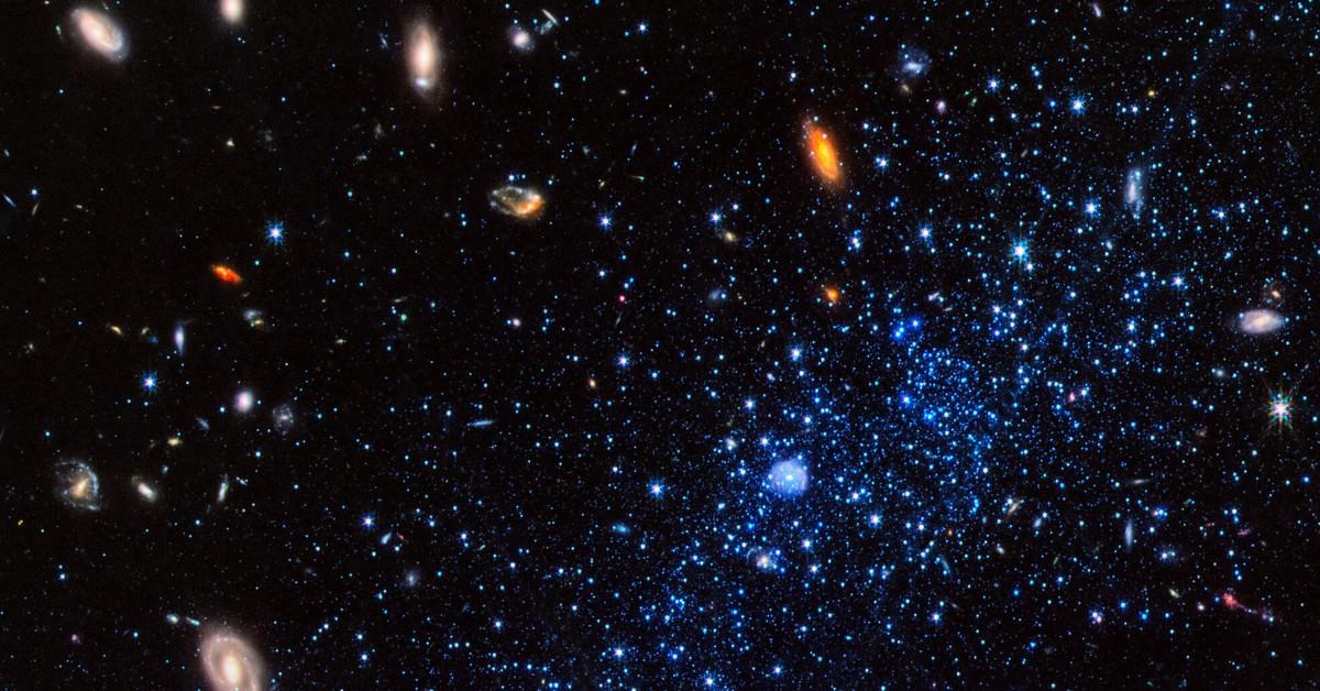 The blue stars from the Leo P Galaxy appear in the bottom right of a photo featuring the organges, blues, yellows, and whites in space