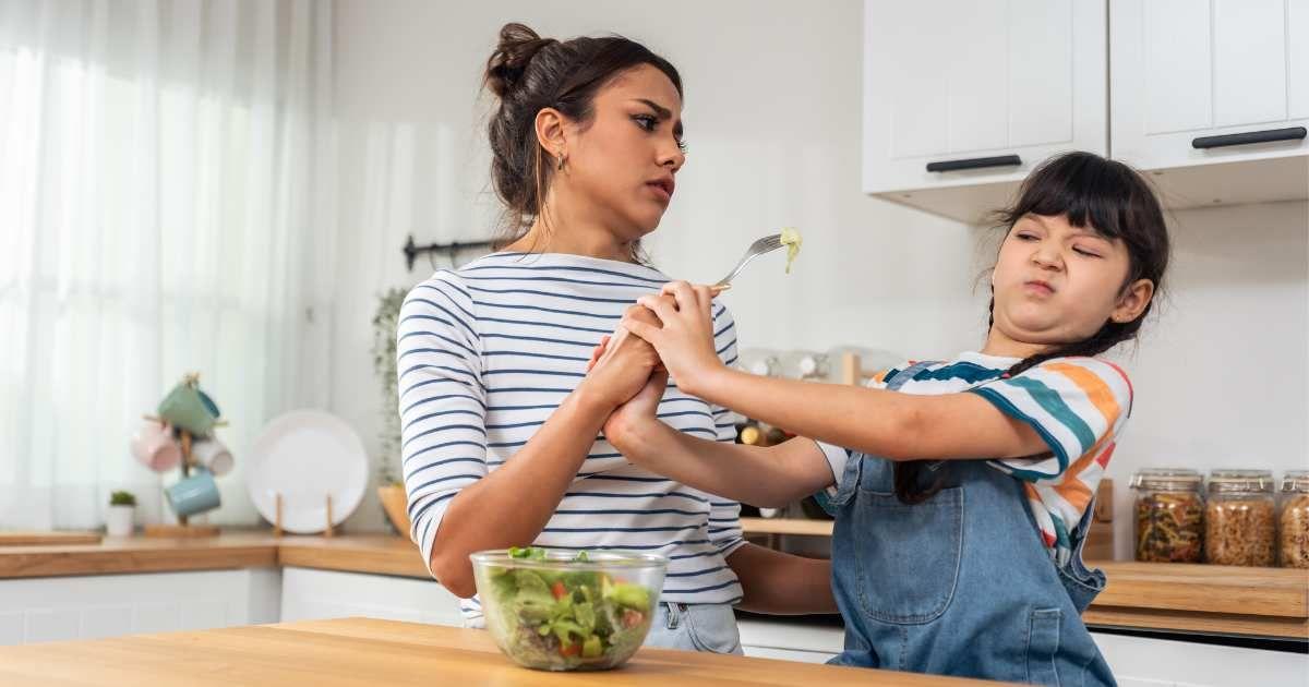 Mother begs young daughter to eat green vegetables but the child refuses abruptly. (Representative Cover Image Source: Getty Images | Kiwis)