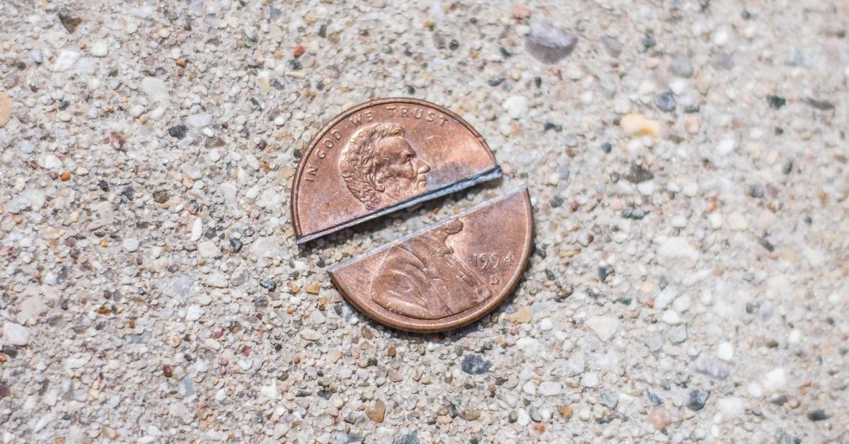 A 1994 penny is cut clean in half