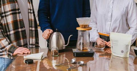 Three people standing beside a table making a coffee. (Representative Cover Image Source: Pexels | Antoni Shkraba)