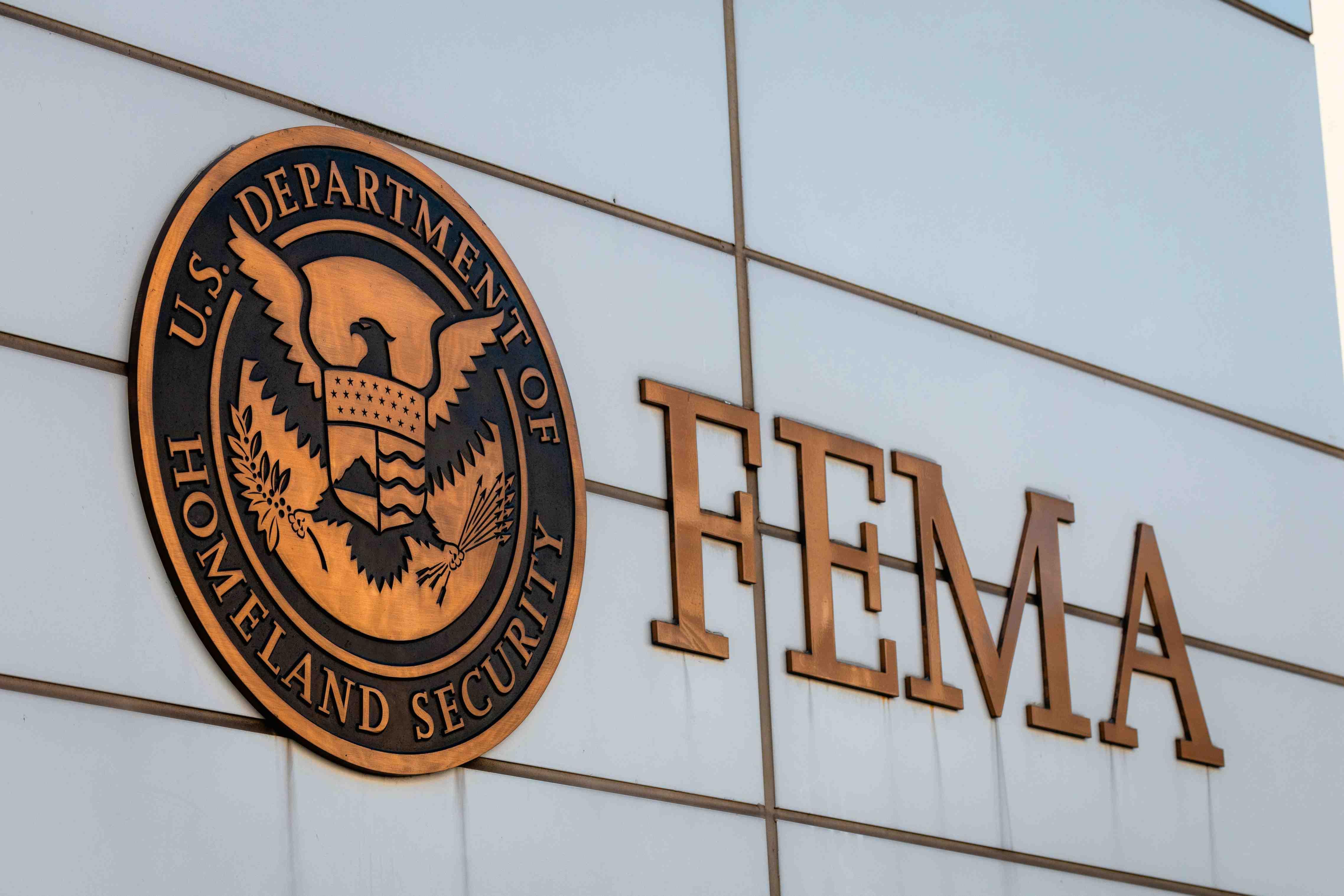 FEMA headquarters is pictured with the logo in gold on a white building.