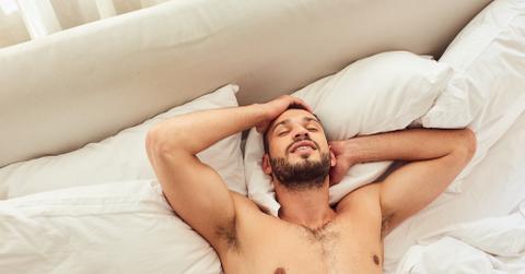 A man smiling and resting in bed