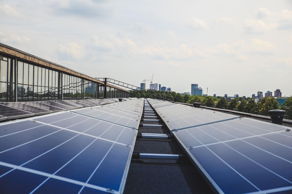 rooftop solar panels with skyscrapers in the background