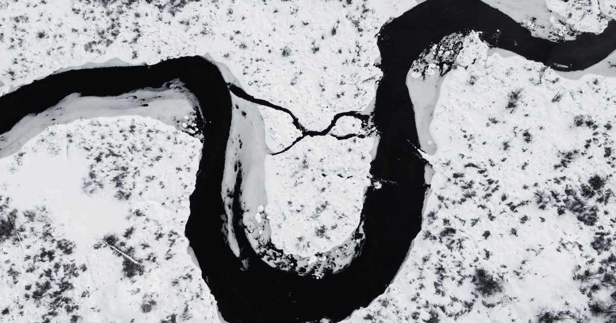 A massive river flowing through an icy landscape. (Representative Cover Image Source: Pexels | Harrison Haines)