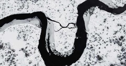 A massive river flowing through an icy landscape. (Representative Cover Image Source: Pexels | Harrison Haines)