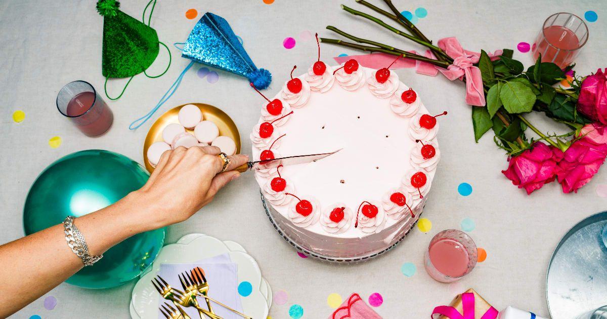 A woman slicing a decorated pound cake (Representative Cover Image Source: Getty Images | Jonathan Knowles)