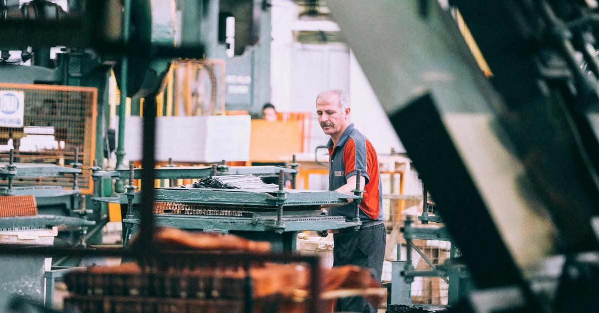 A man works on a machine in a factory