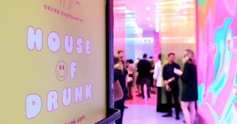 A House of Drunk sign and people mingling at the Drunk Elephant House Of Drunk pop-up on June 10, 2019 in New York City