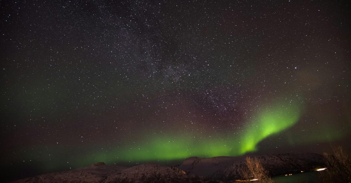 The northern lights visible in a star filled sky