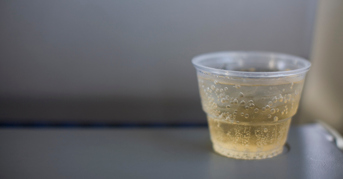 A cup of ginger ale sits on a table