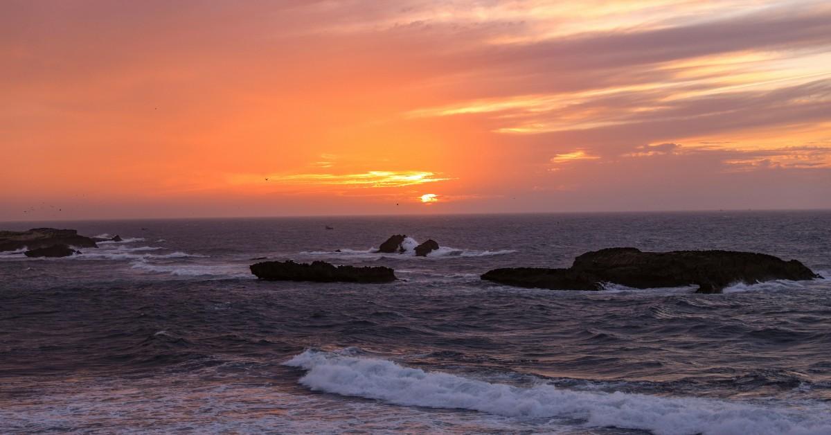 The sun sets over the waters of Essaouira in Morocco