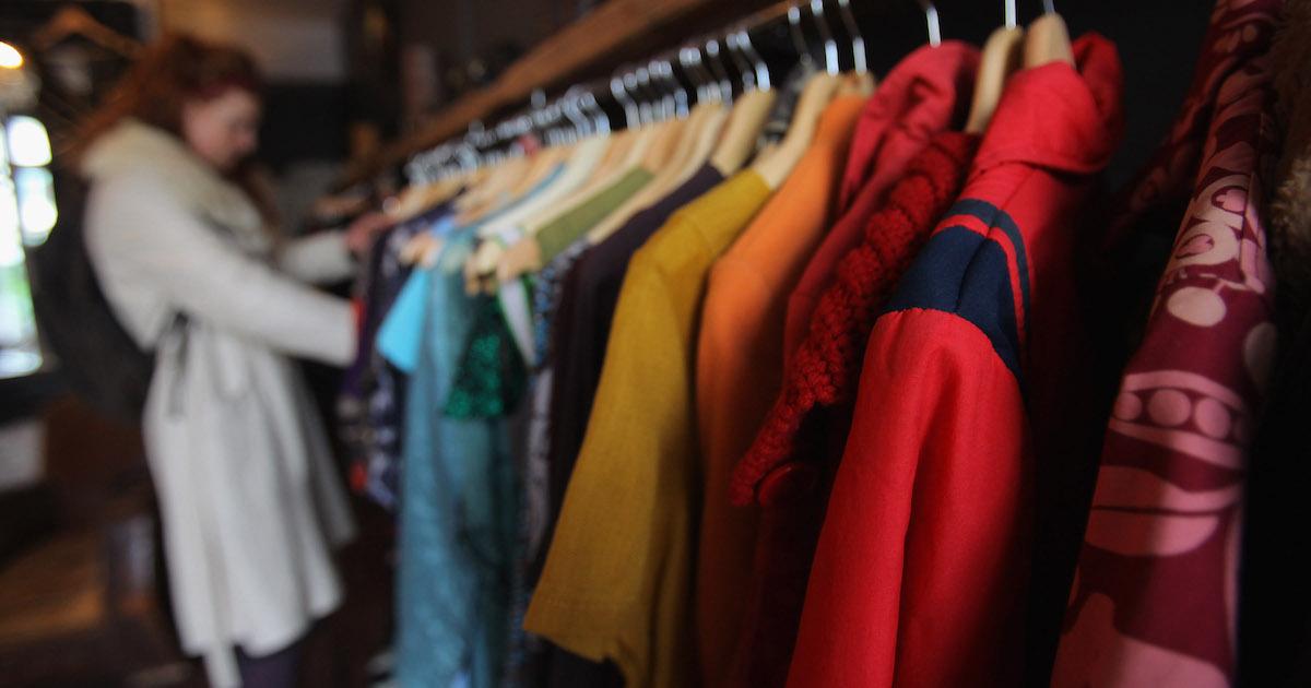 Woman browses racks at a secondhand shop