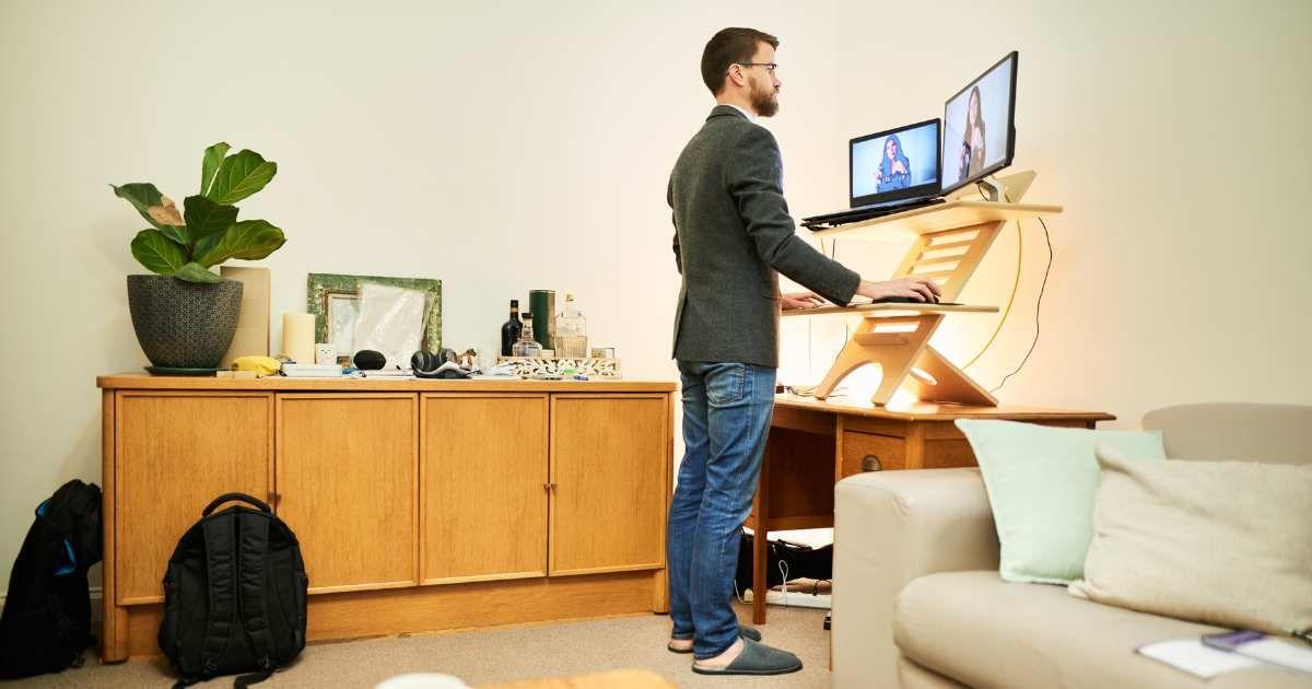 Man working remotely from home at a standing desk (Representative Cover Image Source: Getty Images | AJ_Watt)
