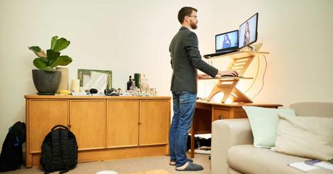 Man working remotely from home at a standing desk (Representative Cover Image Source: Getty Images | AJ_Watt)