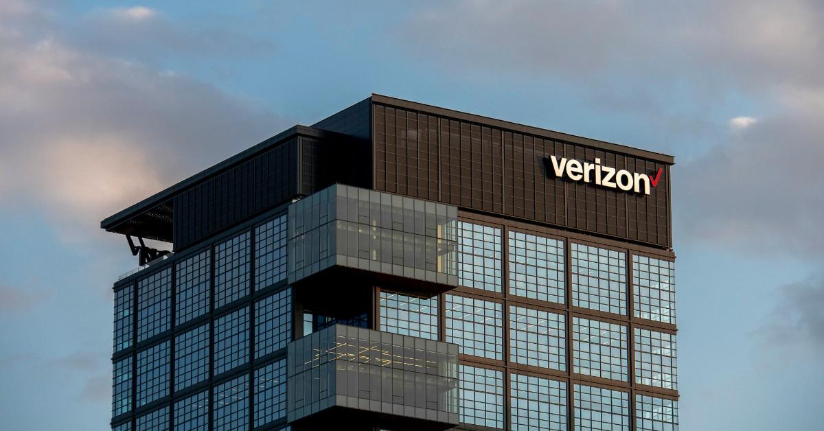 The Verizon logo appears at the top of a skyscraper