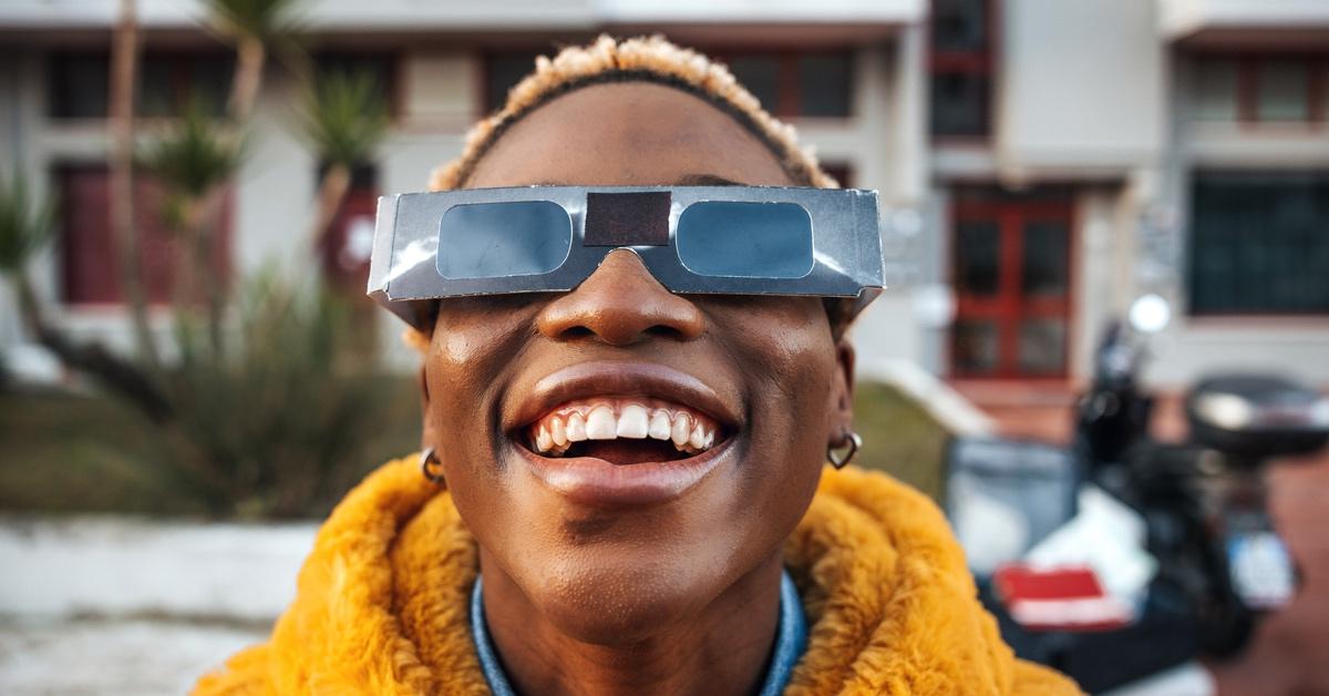 Person wearing solar eclipse glasses