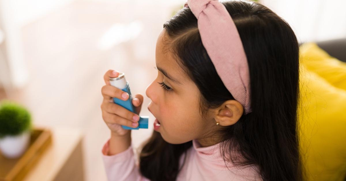 Young girl using an inhaler. 