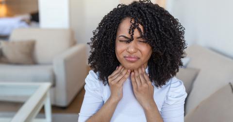 A woman feeling her lymph nodes.