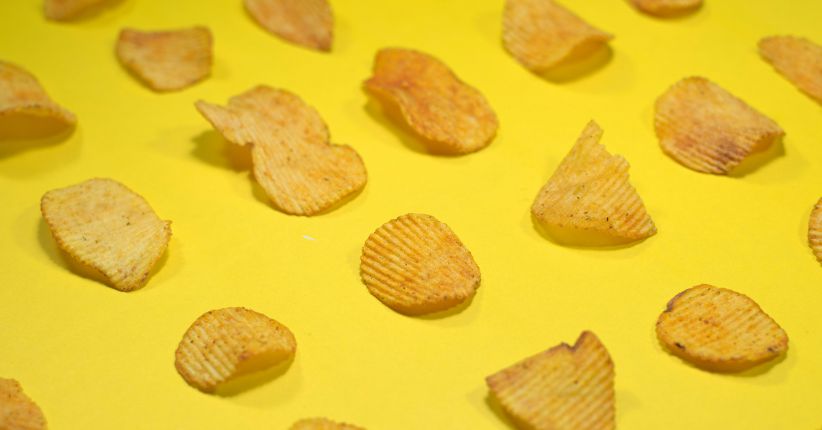 A layer of potato chips sits on a yellow background