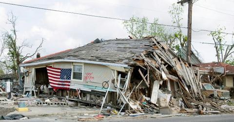 An American flag hangs on a home that has been destroyed by Hurricane Katrina