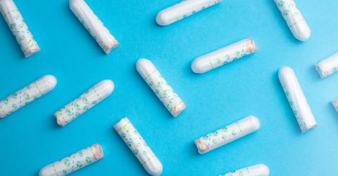 Applicator-free tampons are sprawled out against a blue background