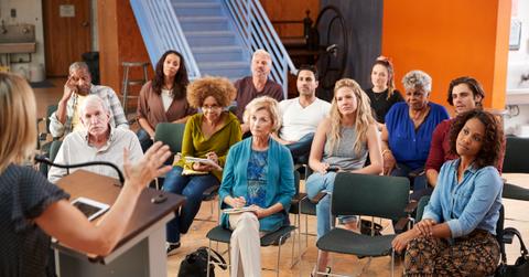 A group of neighbors attend a community HOA meeting.