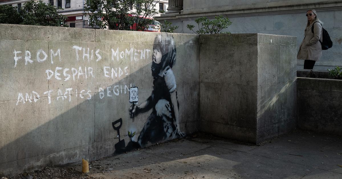  Commuters walk past a piece of street art which is believed to be by the artist known as "Banksy" on April 26, 2019 in London, England.