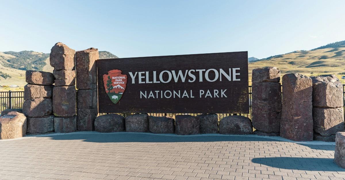 The Yellowstone National Park sign stands at the entrance of the park