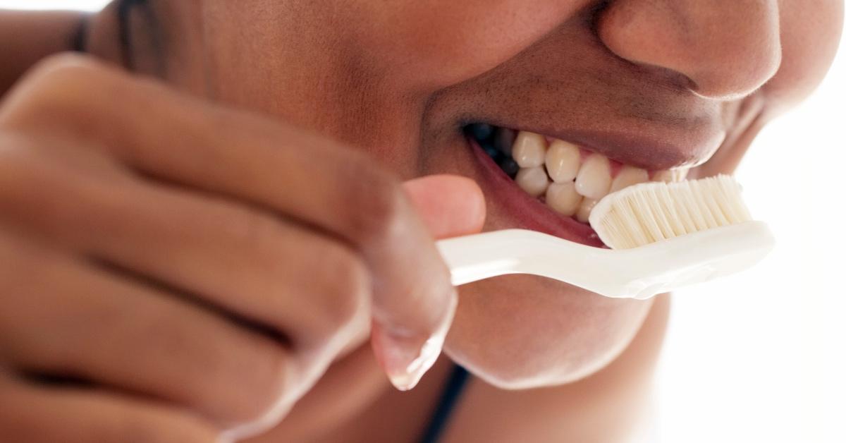 Woman brushing her teeth.