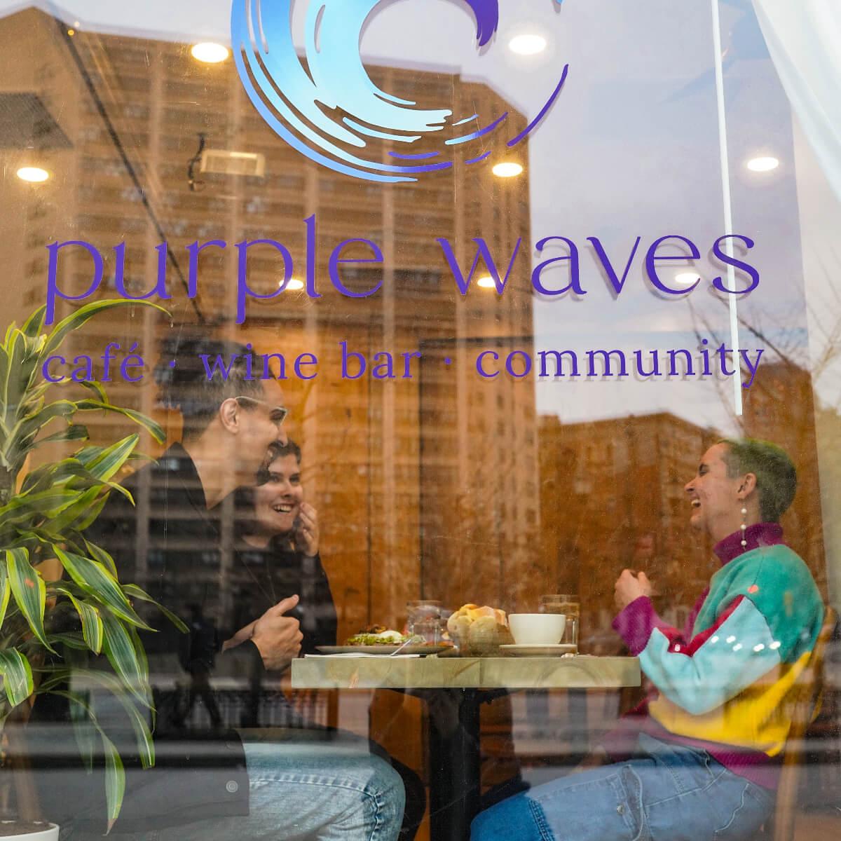 Photo of two patrons eating at NYC's café, coffee shop, and wine bar Purple Waves.