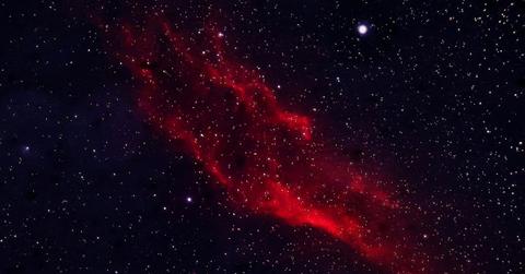 A crimson-red galaxy glowing with stars and bright celestial objects (Representative Cover Image Source: Pexels | Simplyart3794)