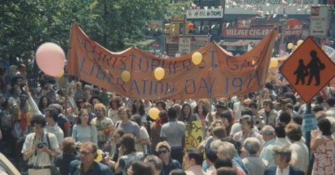 A crowd holds a banner during a protest