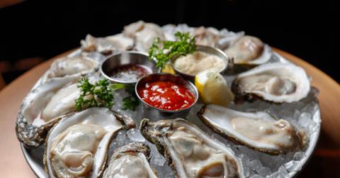 Platter of raw oysters with dipping sauces