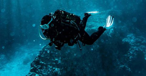 A diver explores the bottom of a river. (Representative Cover Image Source: Pexels | Pia B)