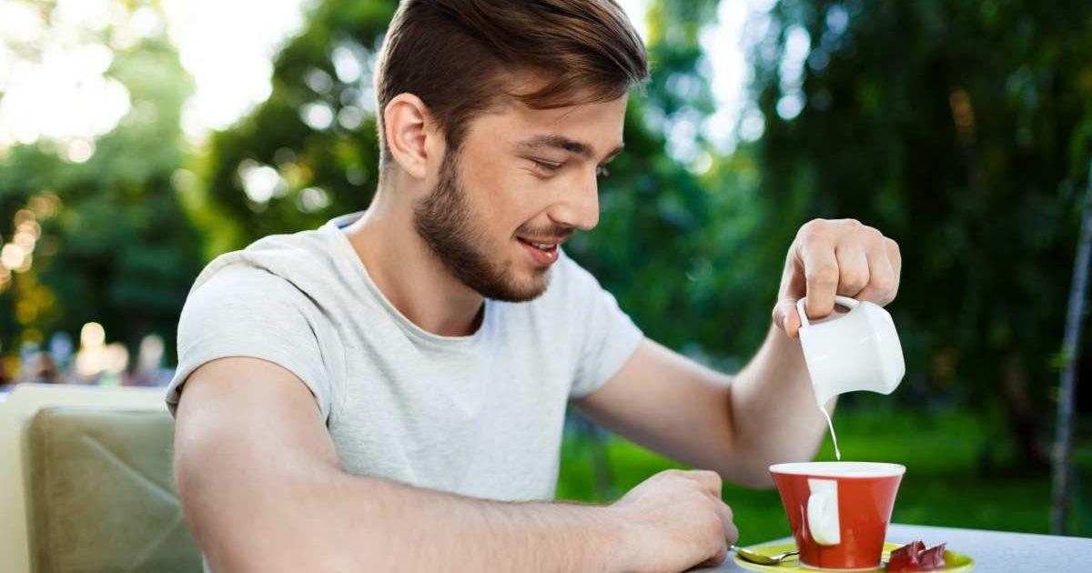 A man is pouring milk into his coffee mug. (Representative Cover Image Source: FreePik | cookie_studio)
