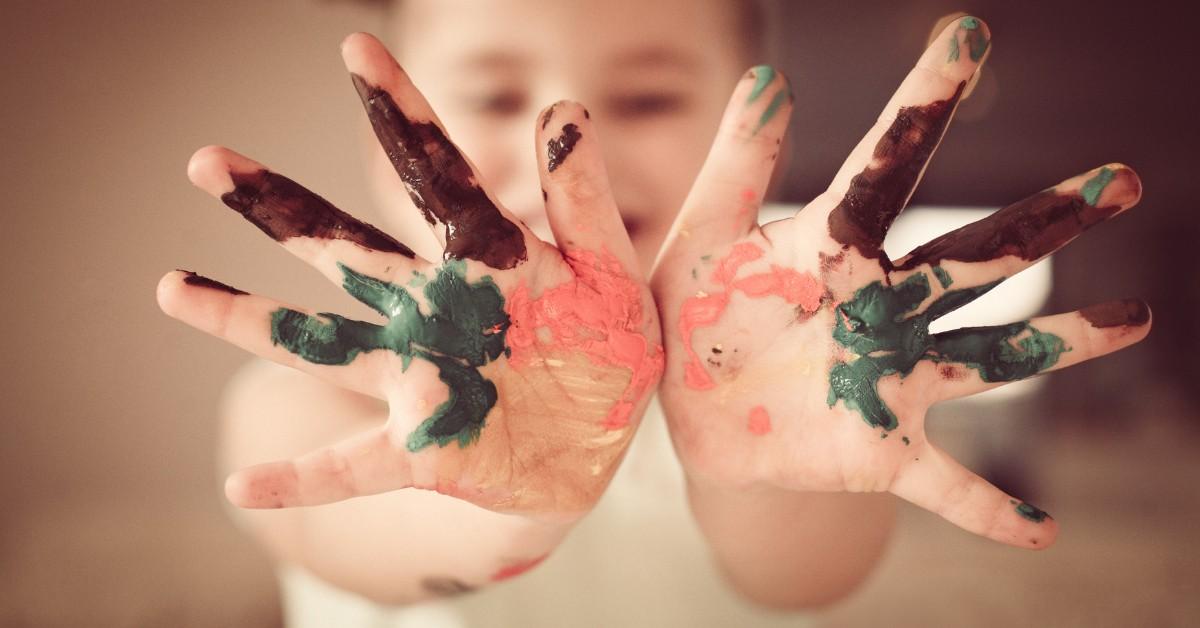 Toddler hands colored in paint