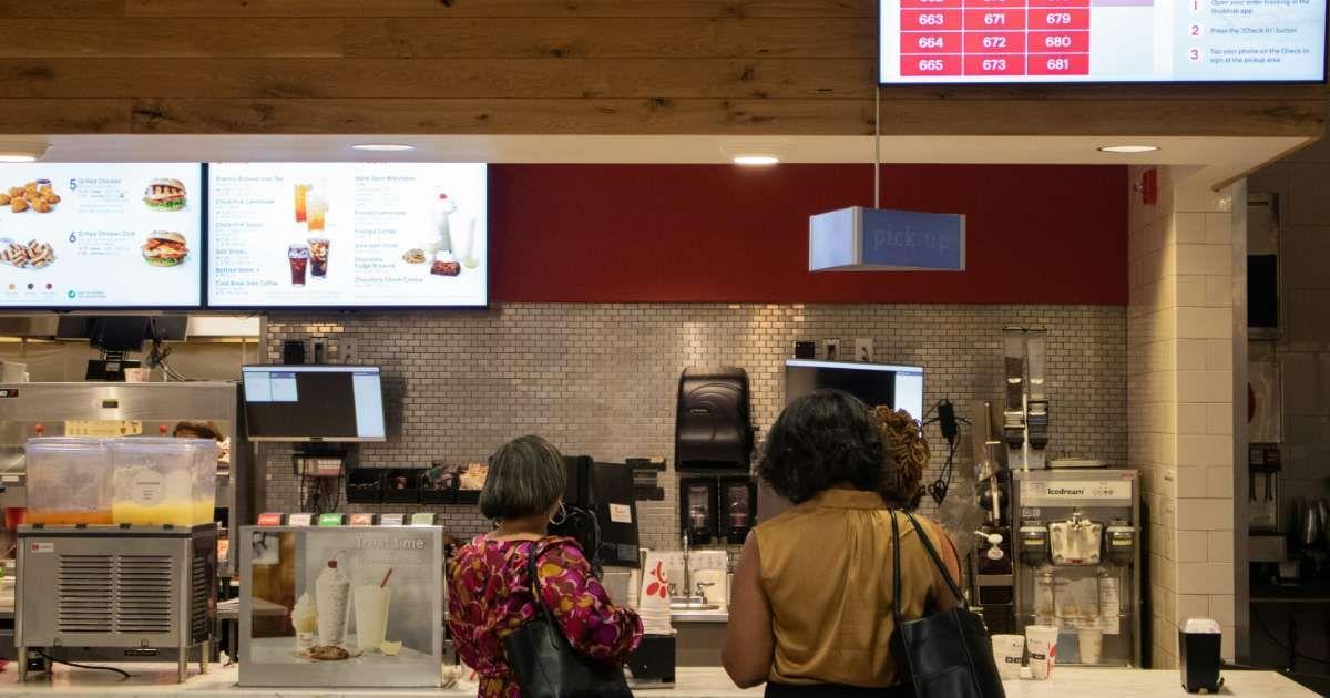 Man with stylish hair eating a burger at a restaurant (Representative Cover Image Source: Unsplash | Zoshua Colah)