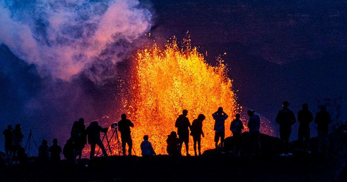 People watch as Hawaii's Kilauea Volcano erupts. (Cover Image Source: Getty Images | Photos By Gary Miller)
