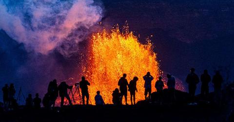 People watch as Hawaii's Kilauea Volcano erupts. (Cover Image Source: Getty Images | Photos By Gary Miller)